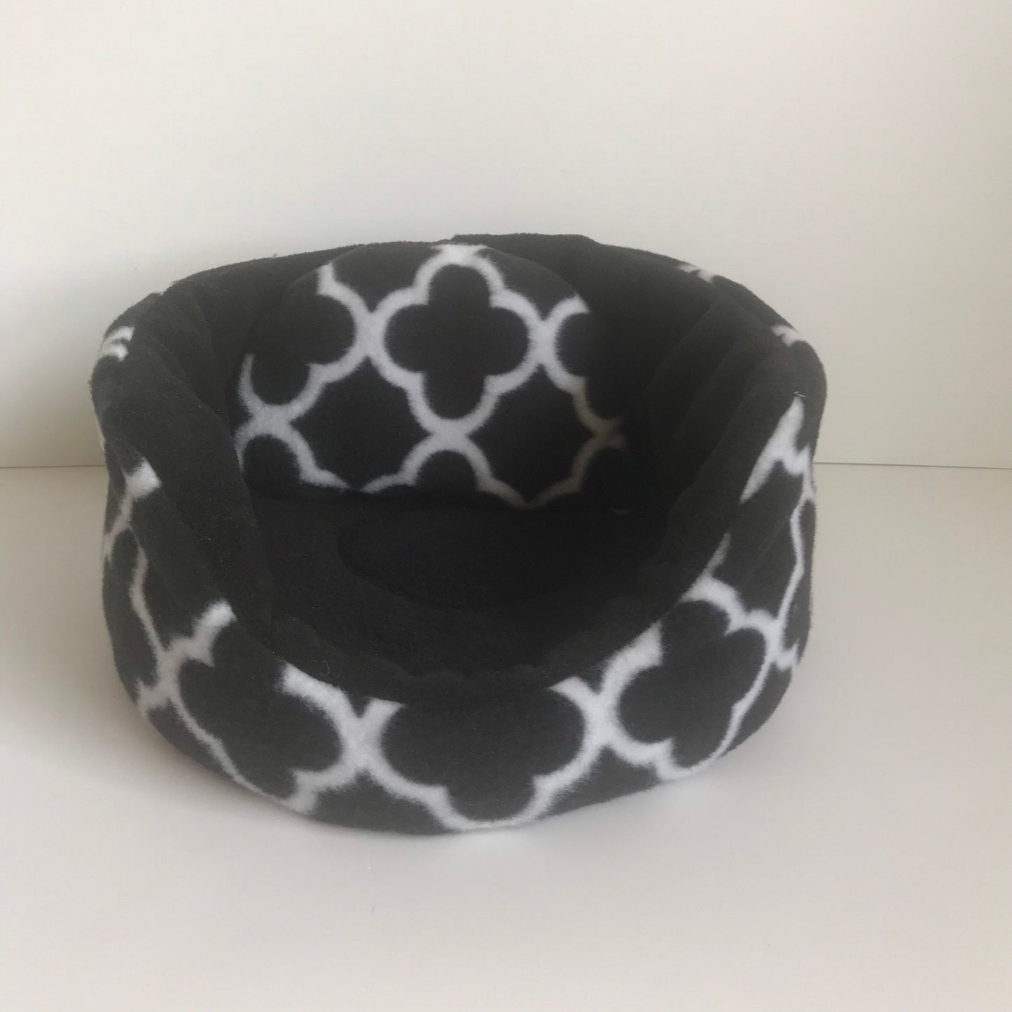 Small round pet bed in black and white fleece print