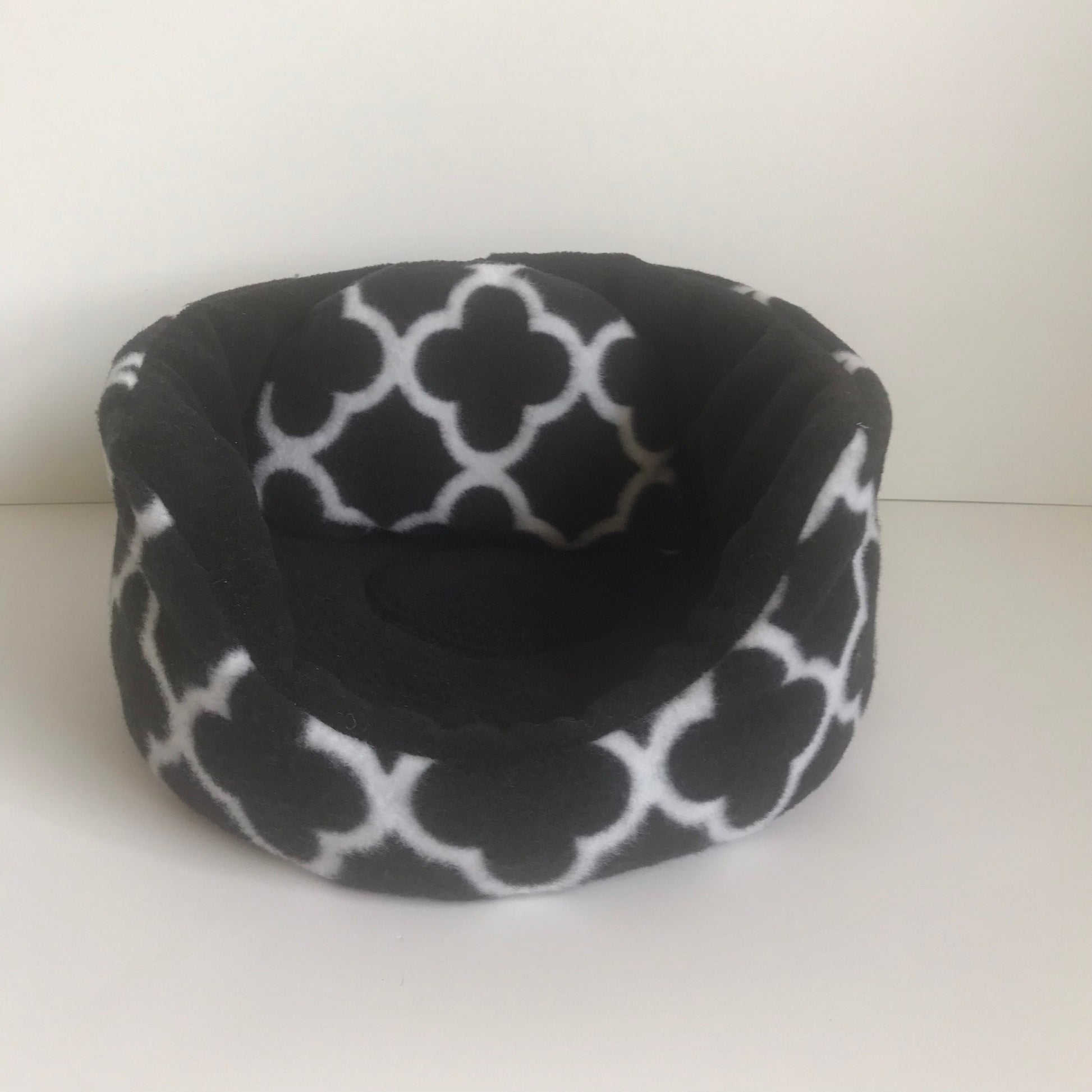 Small round pet bed in black and white fleece print